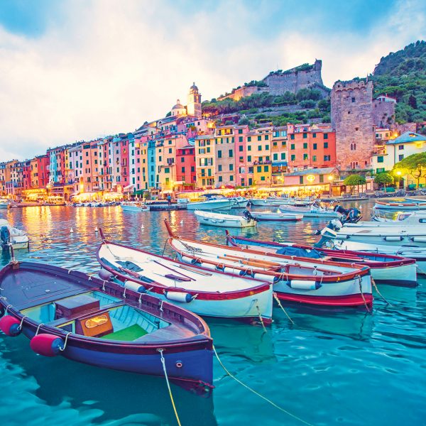 Colourful harbour illustration with boats, and buildings.